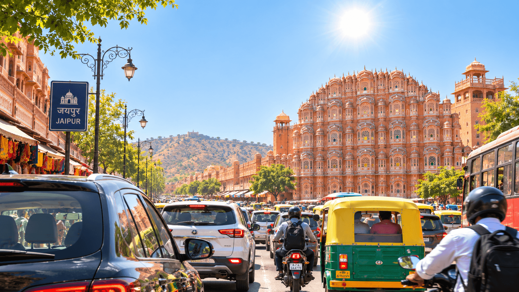 Cars, buses and auto-rickshaws in Jaipur traffic under bright sunlight